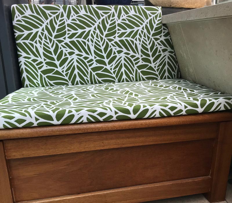 A set of new bespoke outdoor cushions covered in a contemporary floral patterned fabric