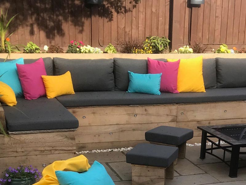 Recovered outdoor cushions for an exterior wicker furniture suite
