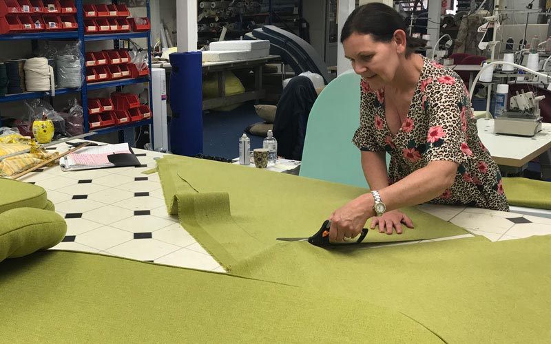 The outdoor cushion cover fabric being cut to size, ready for sewing