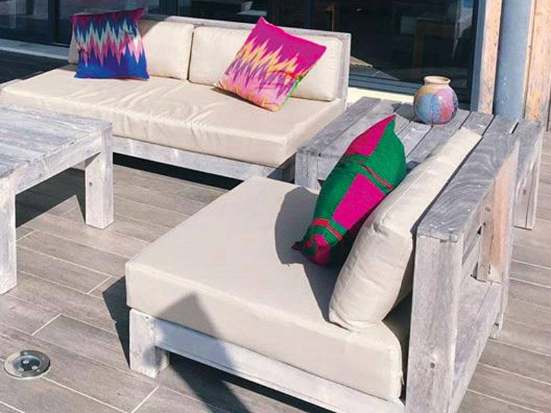 Recovered outdoor cushions for an exterior wicker furniture suite